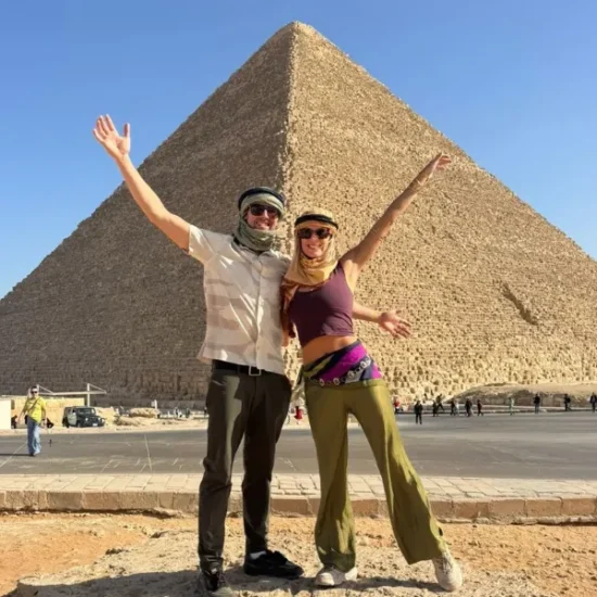Travelers posing in front of the Great Pyramid of Giza during a 5 Days Cairo and Alexandria Tour Package