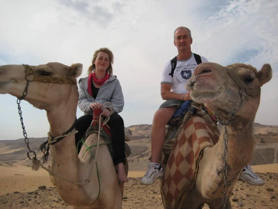 Camel ride through Aswan's landscapes with Egypt Tours Group.