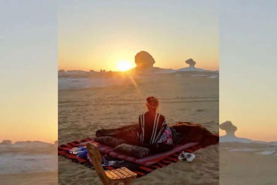 A man enjoying the sun rise view at the White Desert- Bahariya Oasis, Egypt: the Complete Travel Guide to the Western Desert - Egypt Tours Group