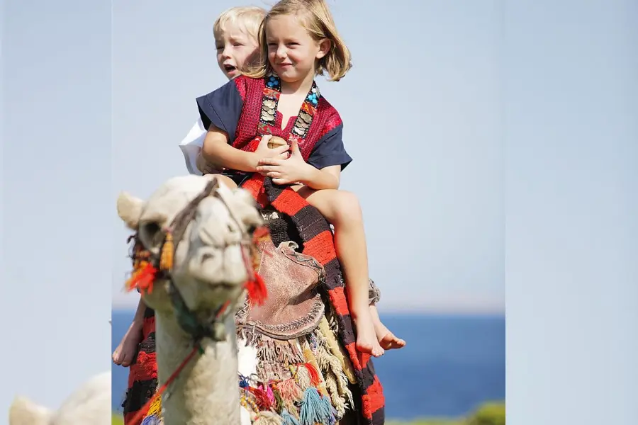 Tourist kids riding a camel in Egypt - Egypt with Kids: The Ultimate Family Travel Guide (2026) - Egypt Tours Group