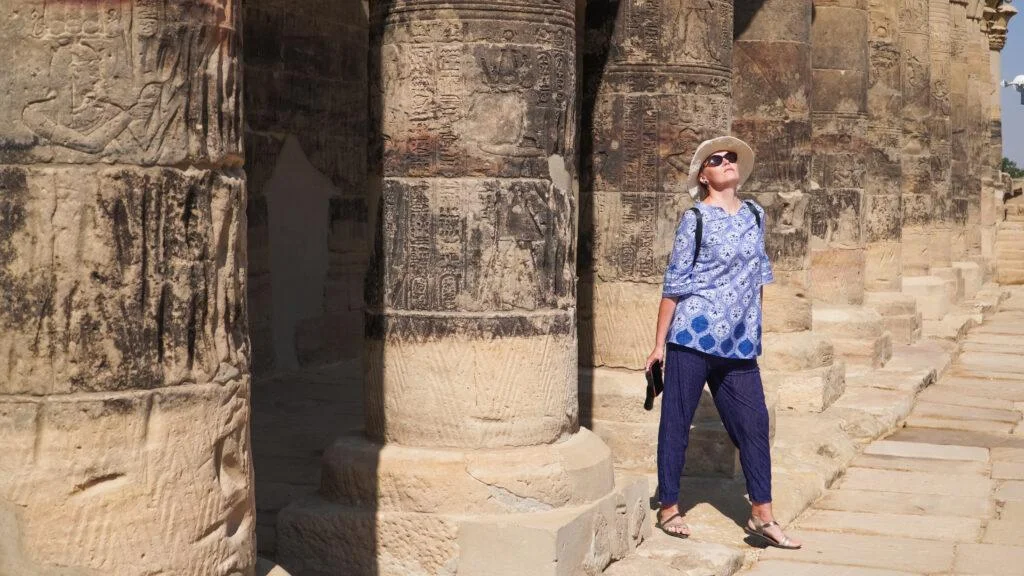 Walking through the columns of Philae Temple in Aswan during Egypt 6 Days Tour