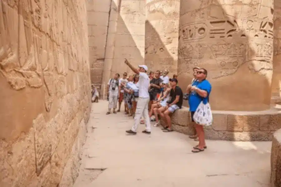 A group of tourists follow their guide - Guided Trips to Egypt: Packages, Prices & Best Itineraries for 2026- Egypt Tours Group