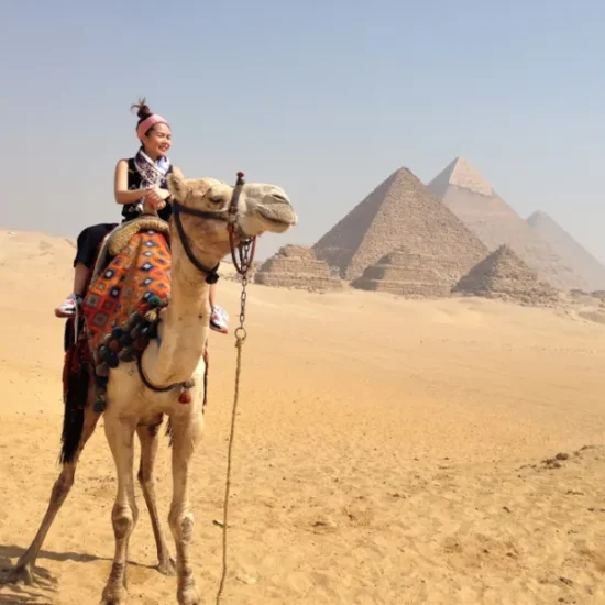 Camel ride near the Giza Pyramids during a 4 Days Cairo & Abu Simbel Tour Package