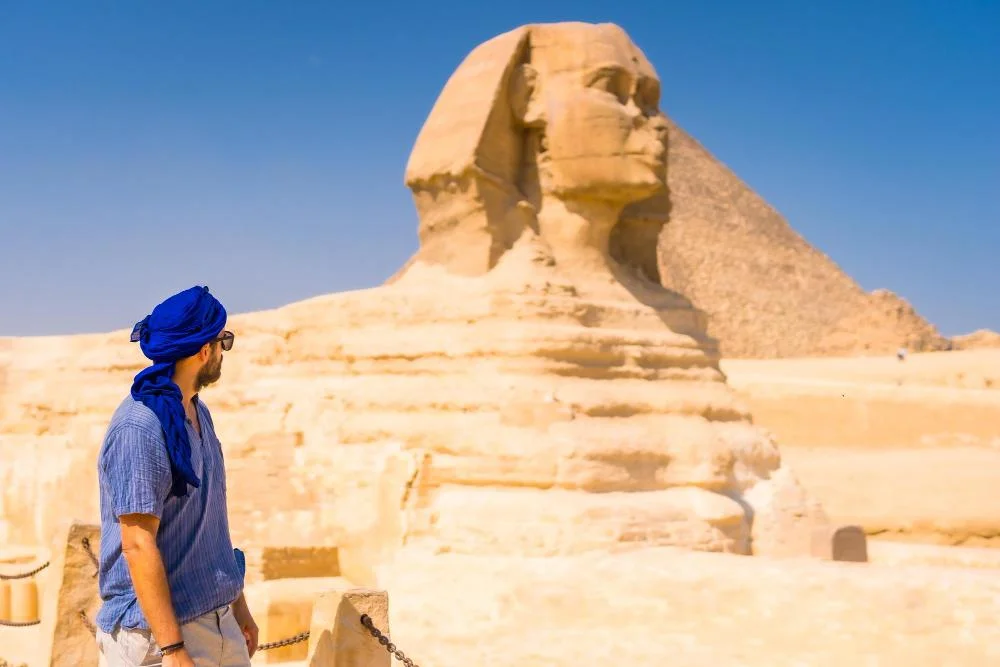 Visitor beside the Great Sphinx on the Giza Plateau