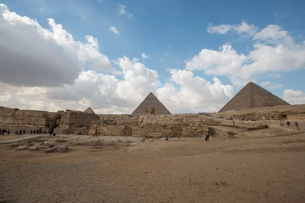 A breathtaking view of the Pyramids of Giza standing tall against the Egyptian desert backdrop