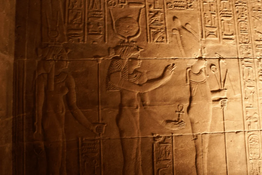 Ancient relief of Isis and Osiris with hieroglyphs at the Temple of Seti I in Abydos