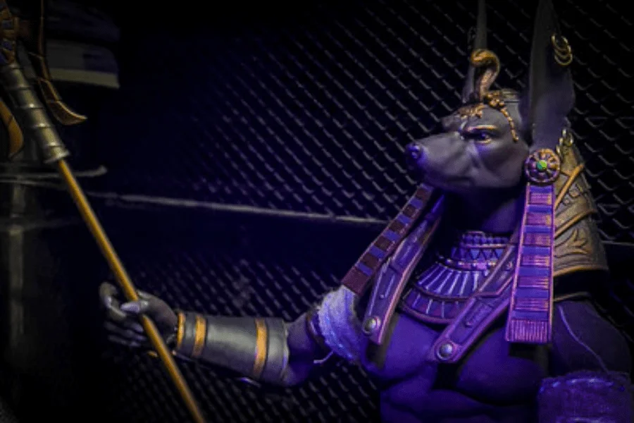 Egyptian dog god Anubis holding scales in the weighing of the heart