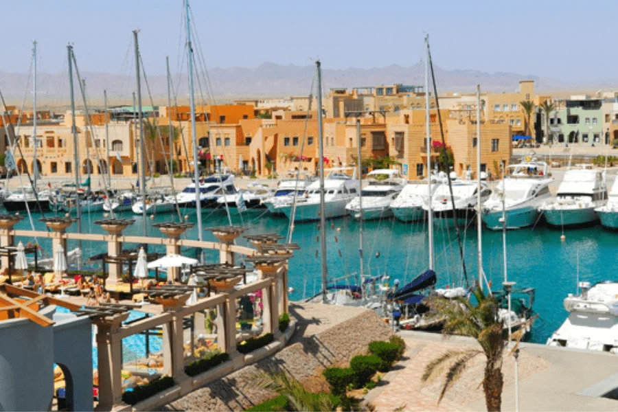 Abu Tig Marina in El Gouna, Egypt, with yachts and waterfront cafes.