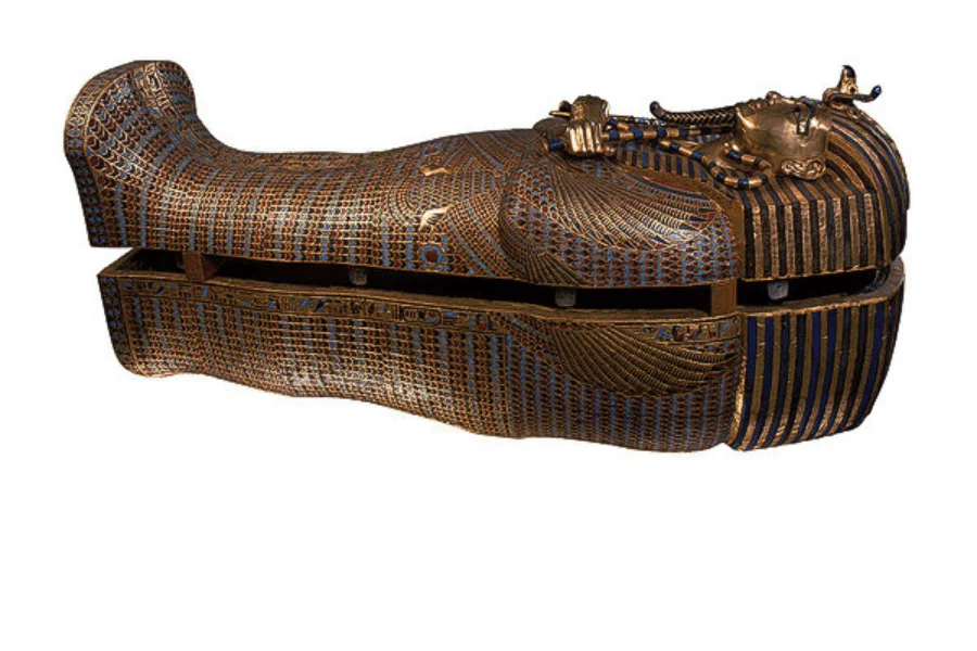 Decorated coffin with a striped headdress and crossed arms