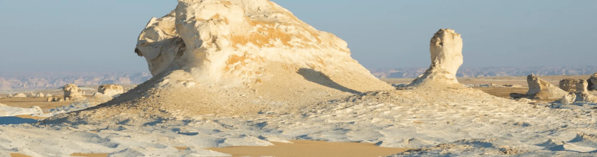 2 Days Bahariya Oasis & White Desert Tour - Unique rock formations in the White Desert, Egypt, under a clear blue sky.