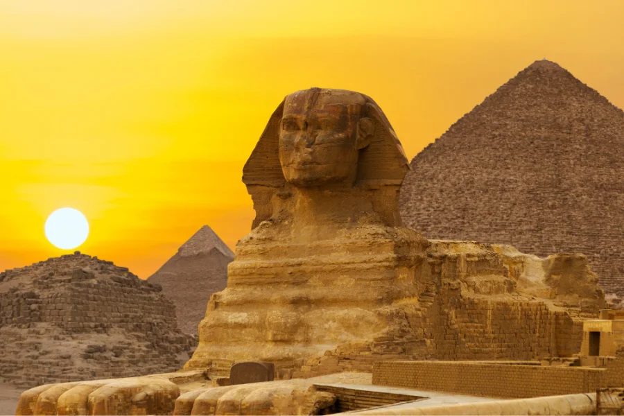 The Pyramids of Giza with the Great Pyramid, desert sands, and the Sphinx in the background - 3 Days Cairo Tour from Luxor by Flight