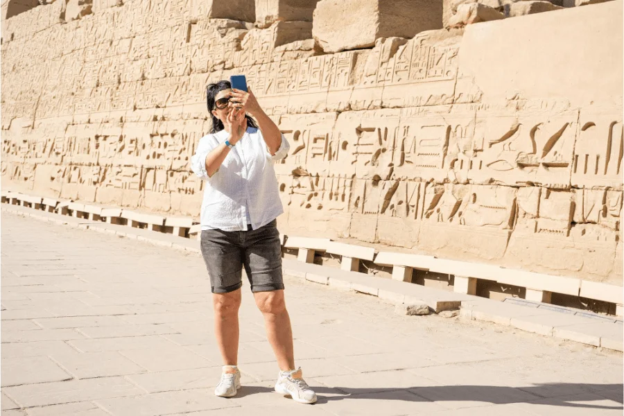 Tourist walking near Egyptian monuments Safe - Egypt Travel Tips 2025