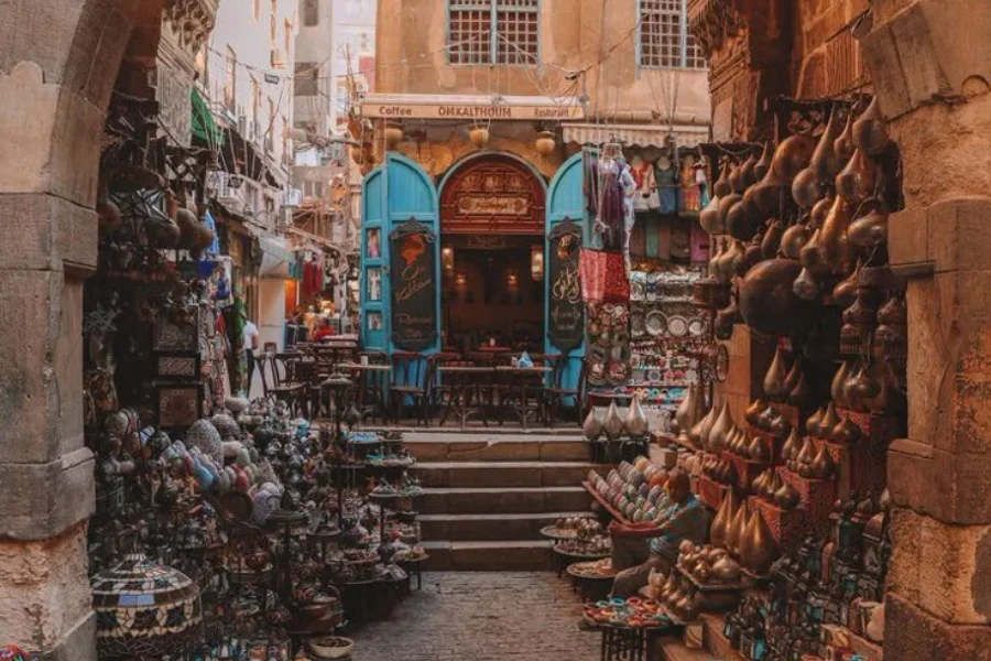 Traditional market scene at Khan El Khalili Bazaar in Cairo with colorful lanterns and shops.