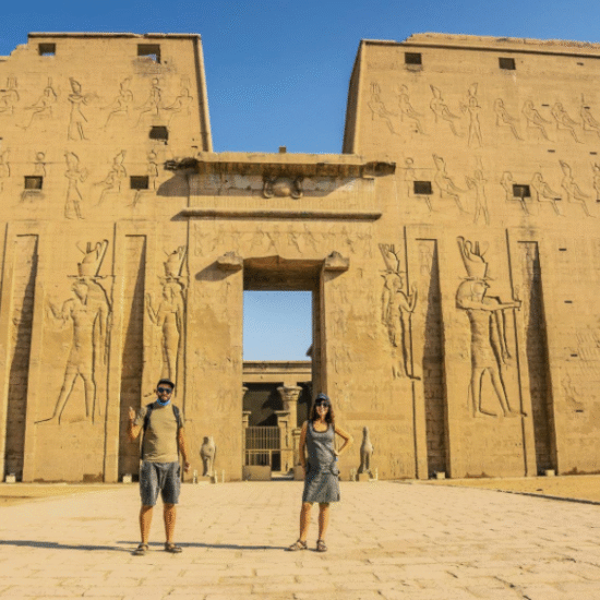 Temple entrance flanked by falcon god statues - 9 Days Cairo, Alexandria & Nile Cruise Easter Holiday