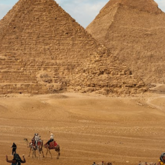 The three pyramids of Giza with the desert and sky in the background, Egypt.