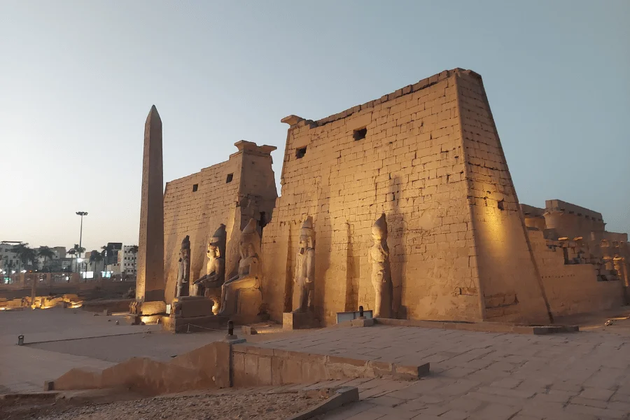 Columns and statues at Luxor Temple at dusk