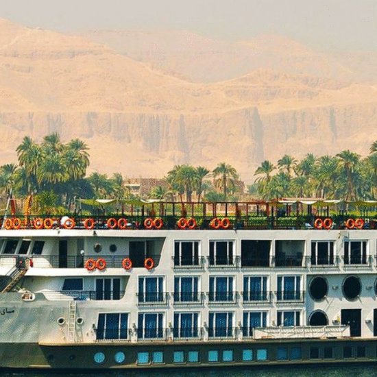 Cruise ship on the Nile River with Cairo skyline - 6 Days Cairo, Luxor, Aswan & Abu Simbel Easter Tour