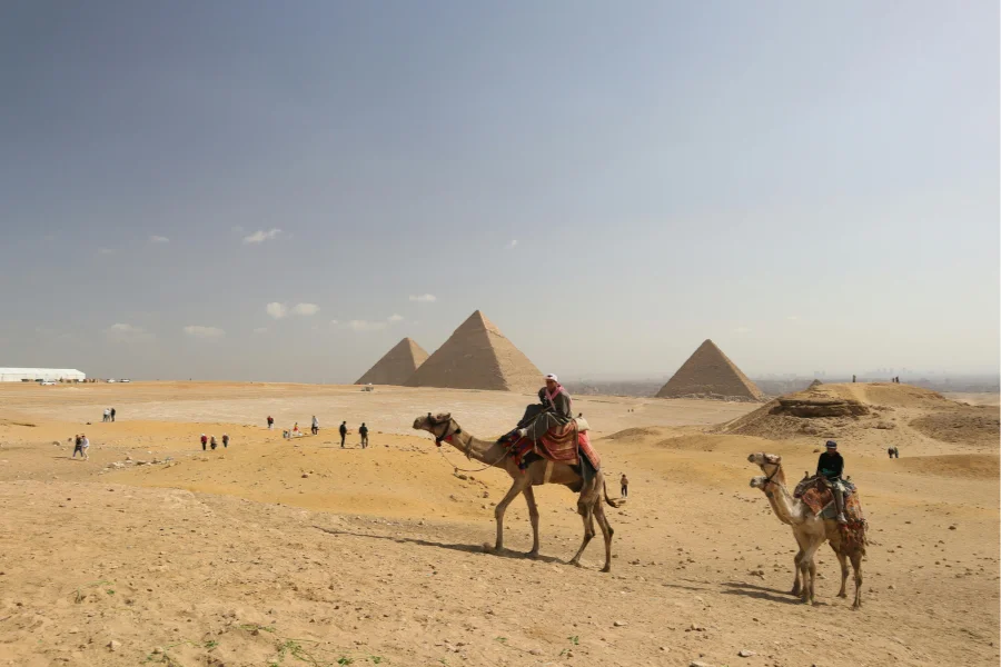 The Giza pyramids with camel riders in the foreground