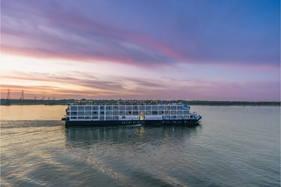 River cruise ship sailing at sunset