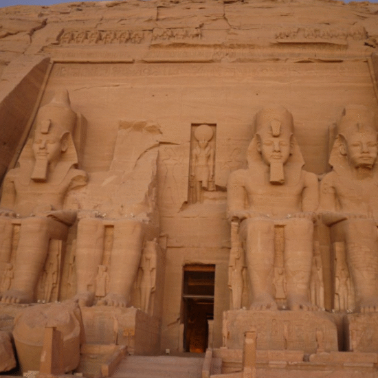 Sunrise illuminating the colossal statues of Ramses II at Abu Simbel Temple