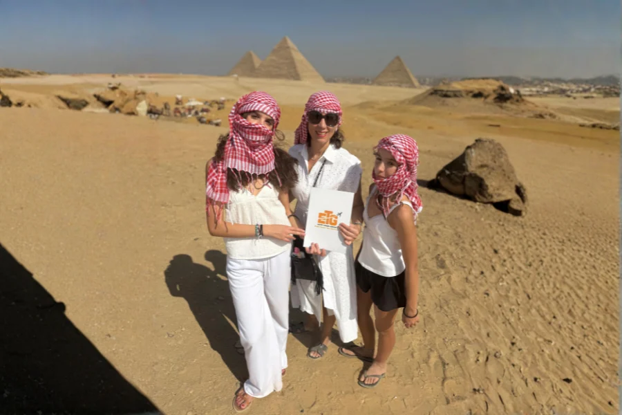 Three female tourists from our company visiting the Great Pyramids of Giza.