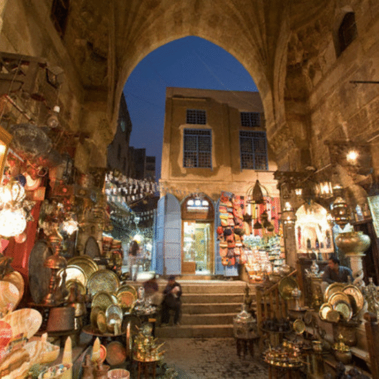 Morning scene at Khan El Khalili Bazaar in Cairo with traditional shops and golden sunlight over the market streets