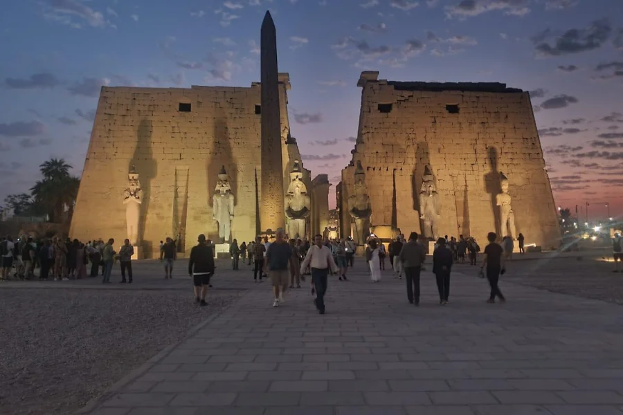 Luxor Temple illuminated at night, showcasing ancient columns and statues in Luxor, Egypt.