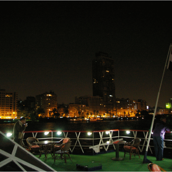 Luxury Nile cruise sailing at sunrise on the calm waters of the Nile River in Egypt