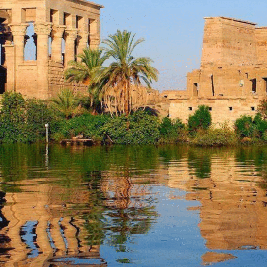 Morning light reflecting on Philae Temple surrounded by the Nile in Aswan