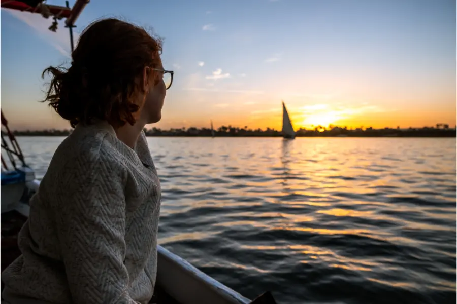 Female Senior enjoying Nile River - Why choose tours for seniors in Egypt