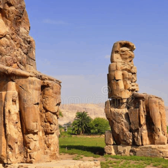 Colossi of Memnon standing under bright daylight