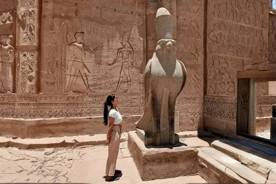 A girl standing in front of Edfu Temple entrance