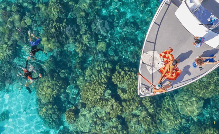 Tourists snorkeling from a boat in the Red Sea near Hurghada, Egypt.