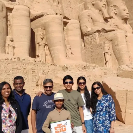 A family standing in front of Abu Simbel Temple in Egypt