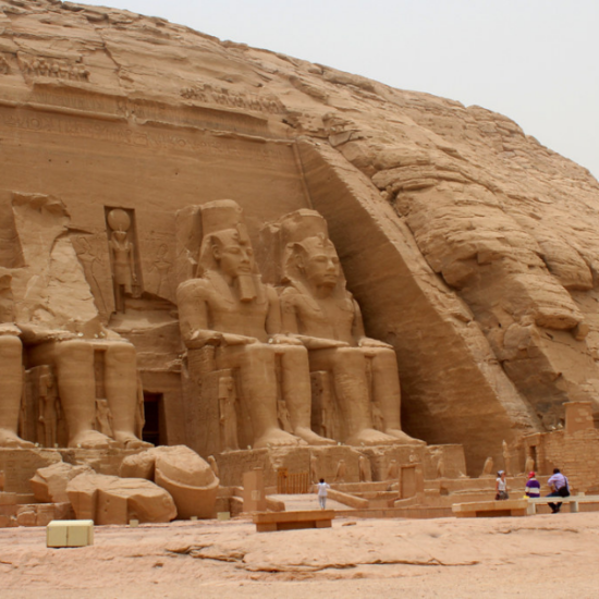 An elderly man standing in front of Abu Simbel Temple