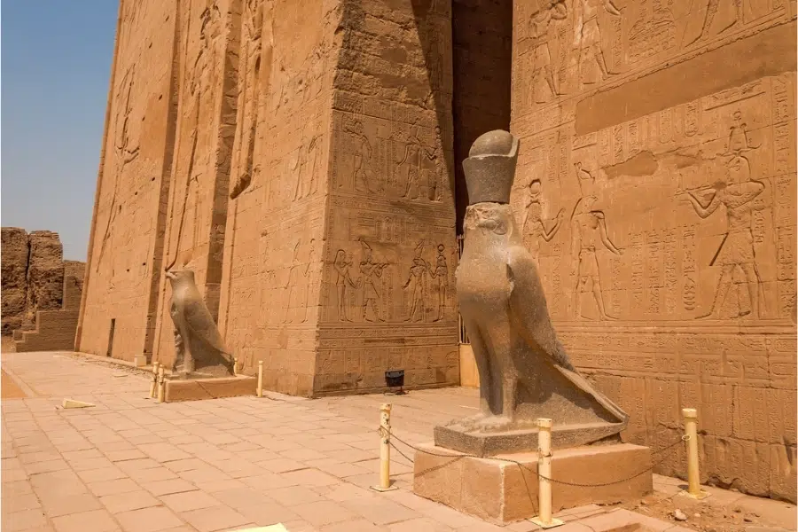 Priests and Pharaoh statues guarding divine order at Edfu Temple