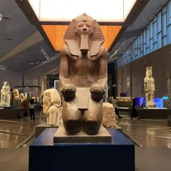 An ancient Egyptian statue displayed inside the Grand Egyptian Museum