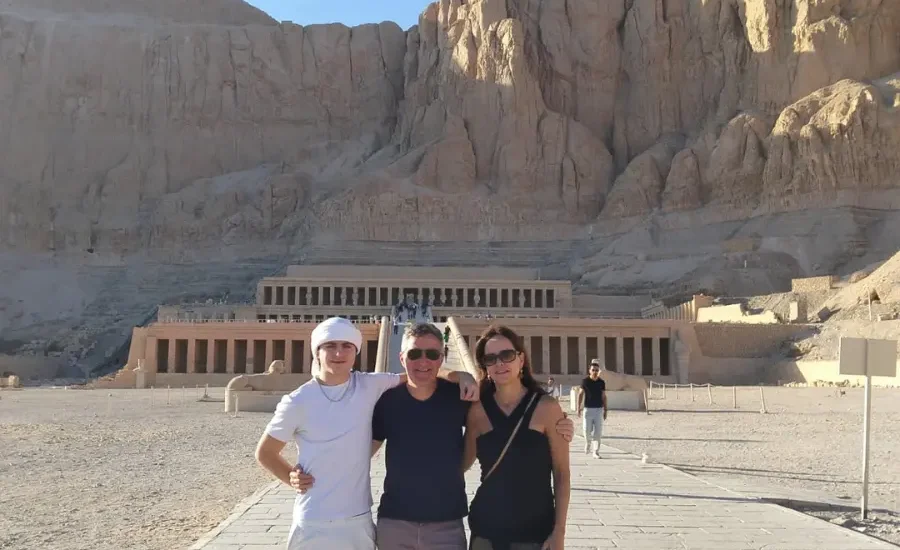 A family standing in front of Hatshepsut Temple in Luxor