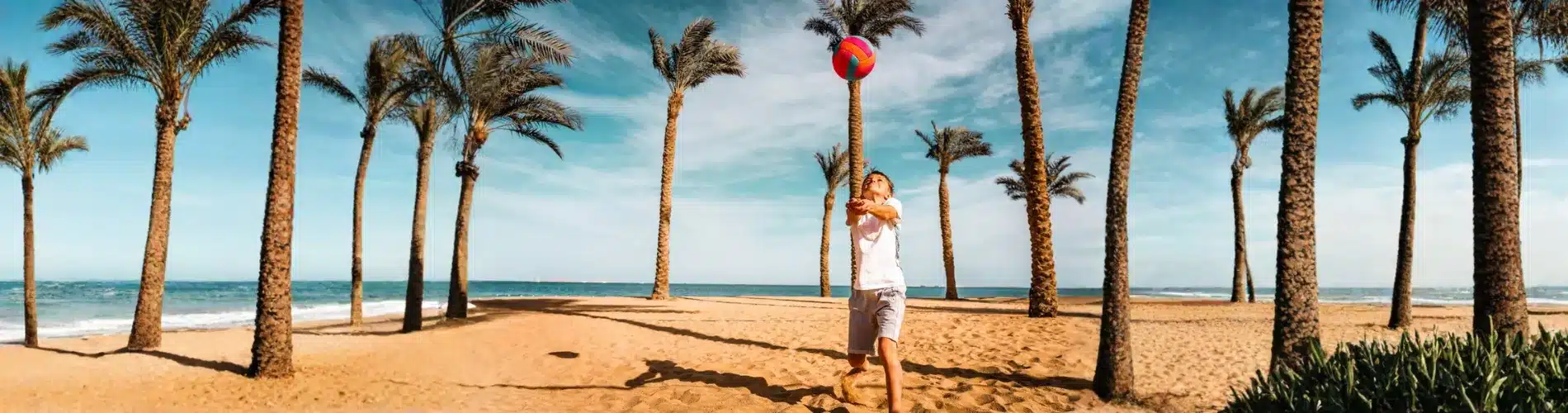 Child playing volleyball on Hurghada beach as a part of our 14 Days Cairo, Bahariya Oasis, Luxor & Hurghada Family Tour