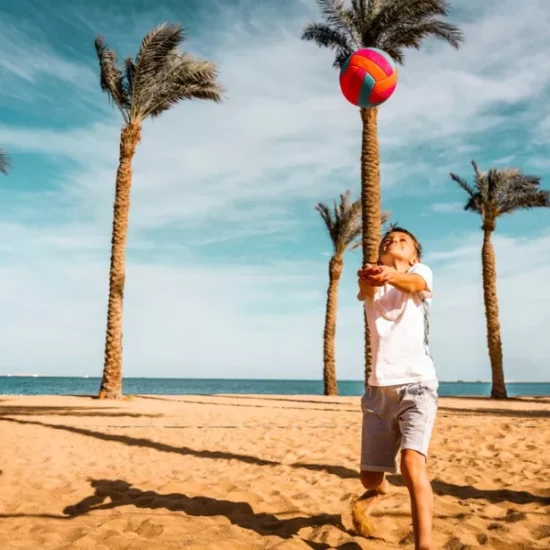 Child playing volleyball on Hurghada beach