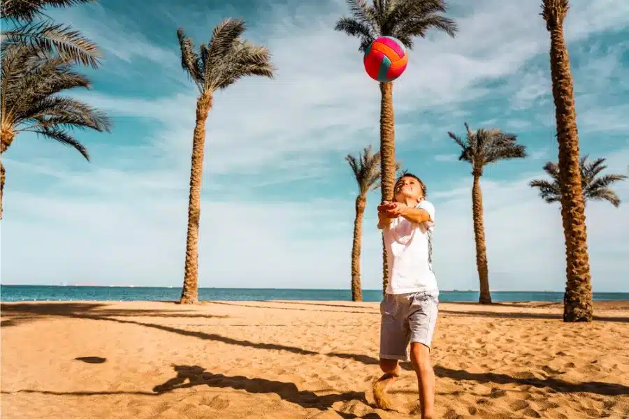 Child playing volleyball on Hurghada beach