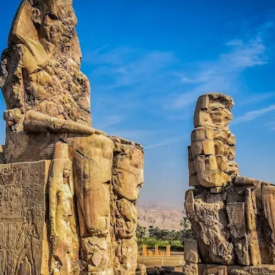 Colossi of Memnon statues by day in Luxor