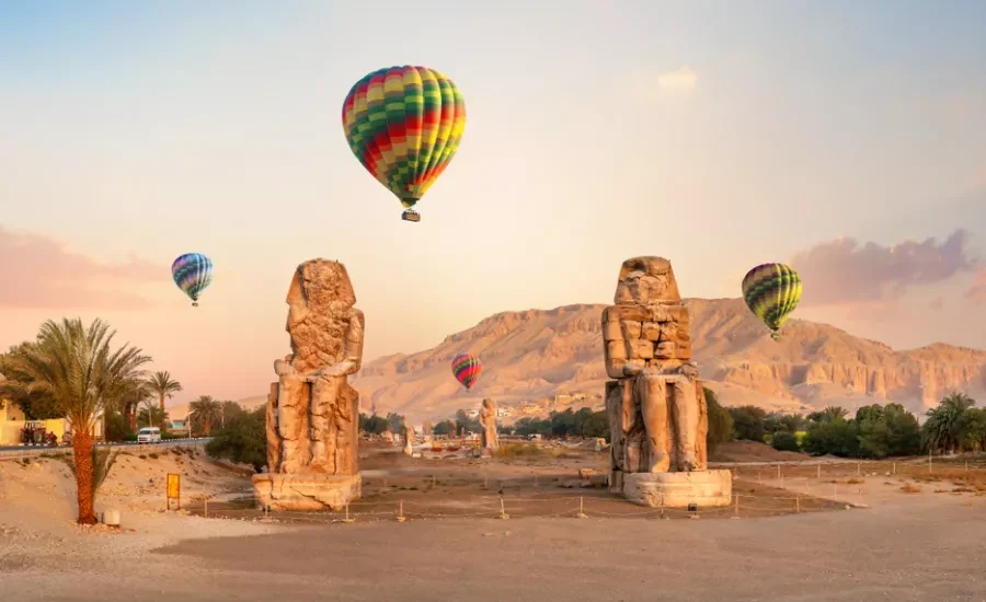 Colossi of Memnon with hot air balloons, a part of our 12 Days Cairo, Nile Cruise & Sharm El Sheikh Family Tour