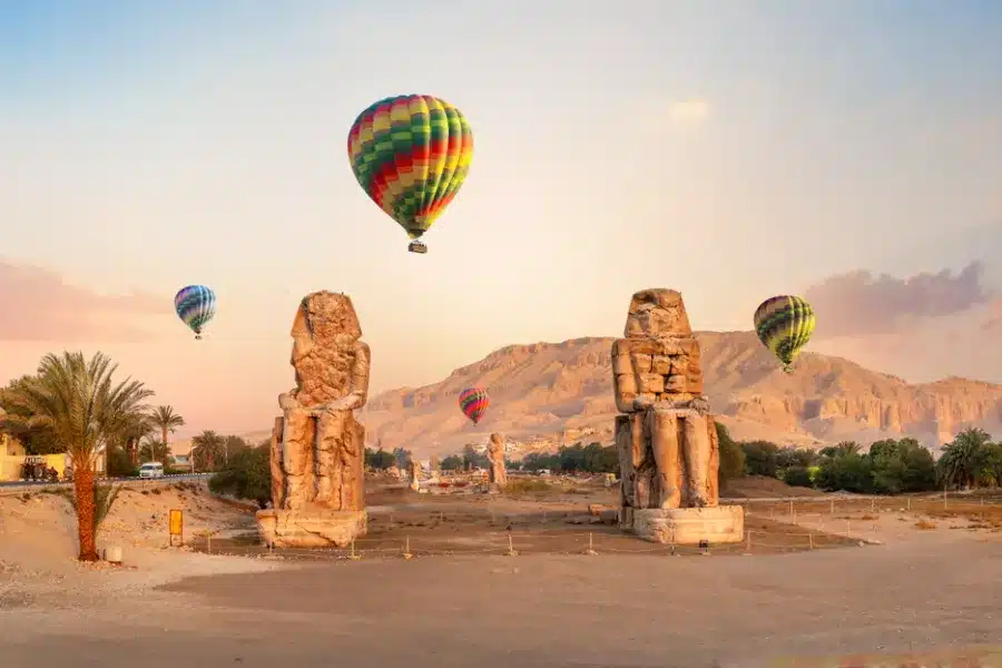 Colossi of Memnon with hot air balloons, a part of our 12 Days Cairo, Nile Cruise & Sharm El Sheikh Family Tour