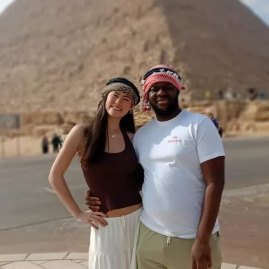 Couple standing in front of the Giza Pyramids