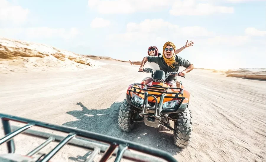 Couple riding beach buggy in Sharm desert