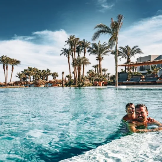Father and son enjoying hotel swimming pool in Hurghada