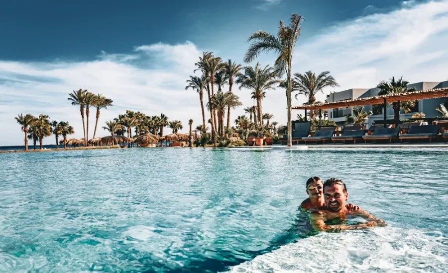 Father and son enjoying hotel swimming pool in Hurghada