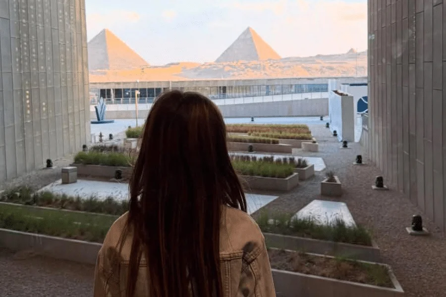 Guest inside the Grand Egyptian Museum with pyramids view as a part of our 6 Days Cairo and Nile Cruise Family Holiday