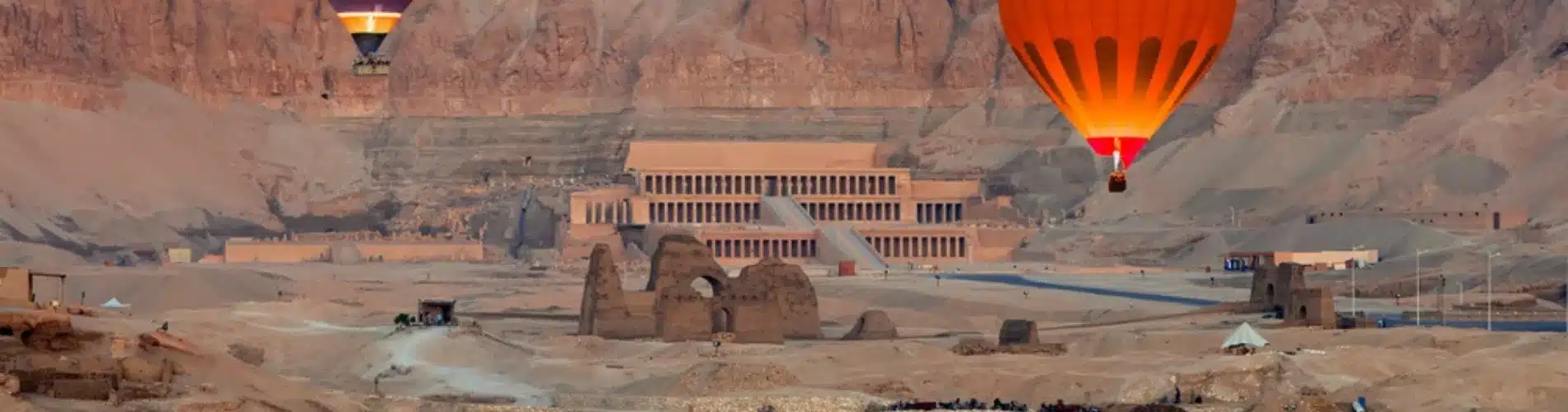 Hatshepsut Temple with hot air balloons as a part of our 11 Days Cairo, Nile Cruise and Alexandria Family Tour Package
